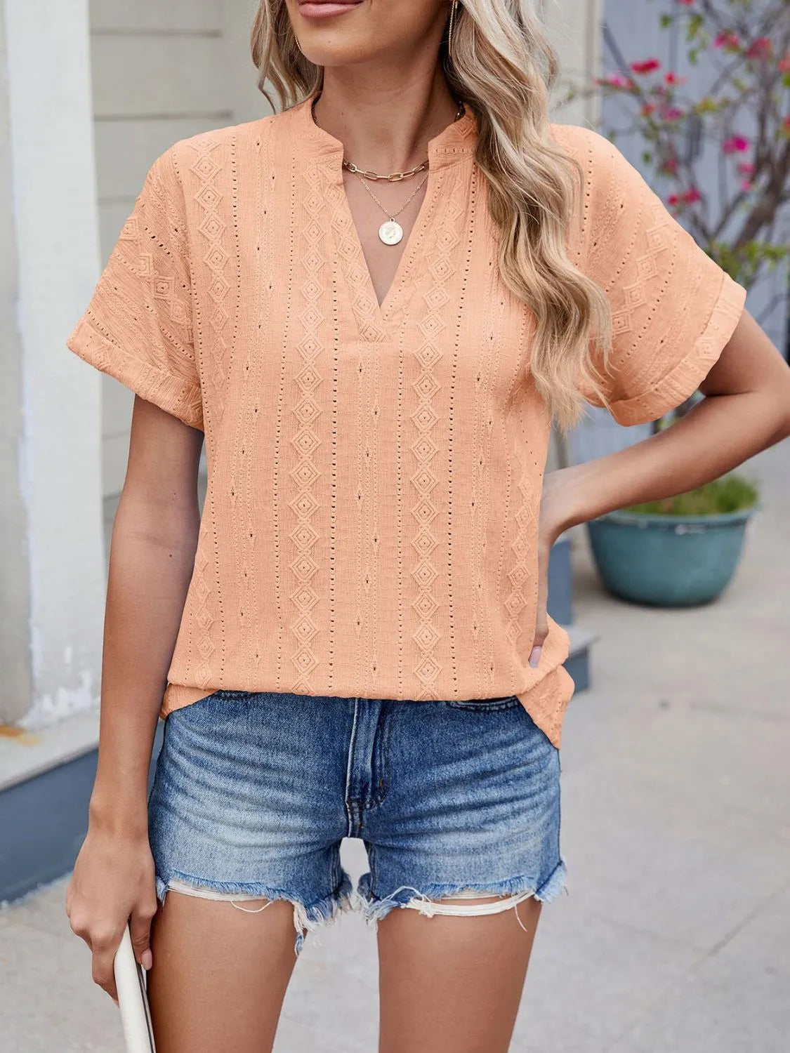 Eyelet notched short sleeve top.