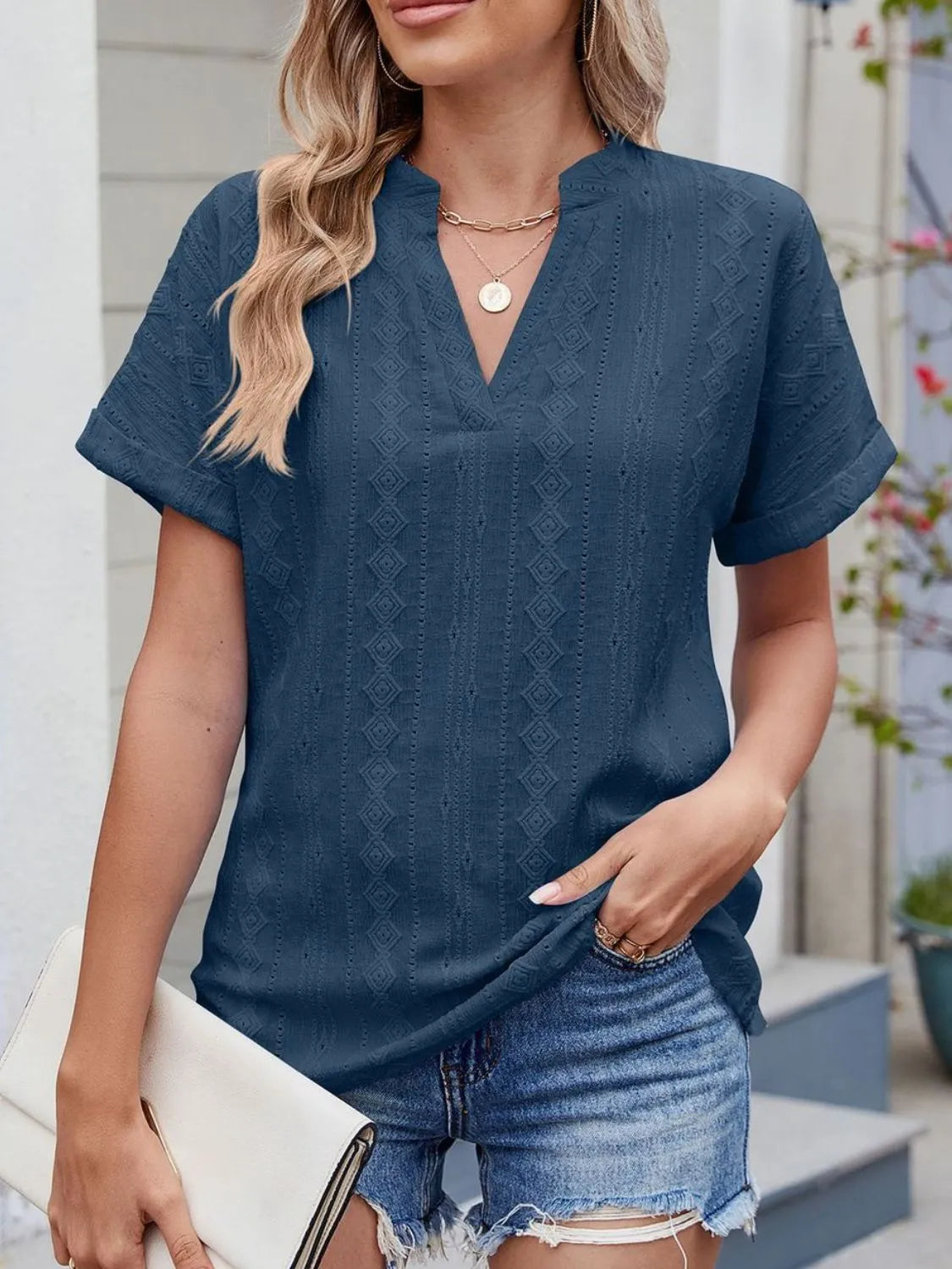 Eyelet notched short sleeve top.