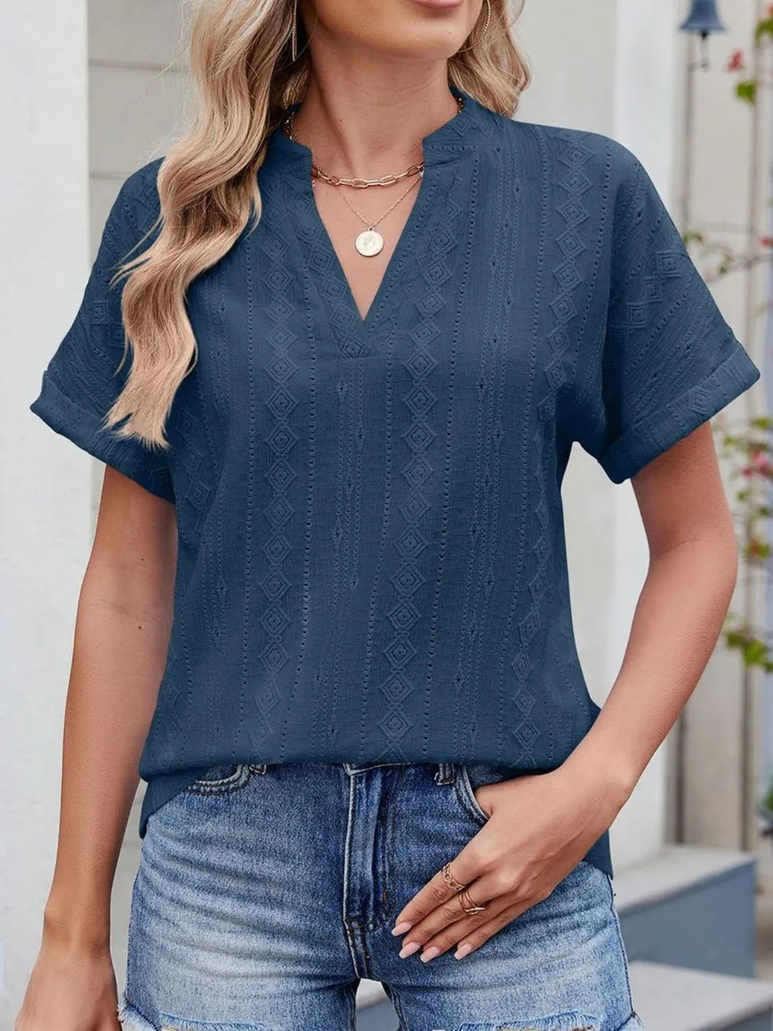 Eyelet notched short sleeve top.