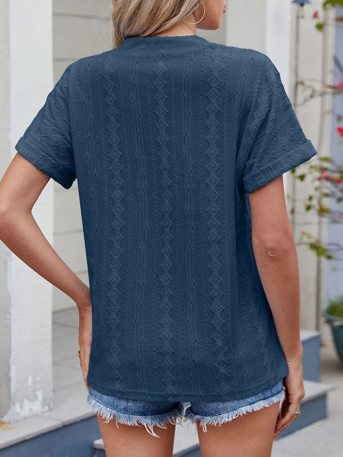 Eyelet notched short sleeve top.