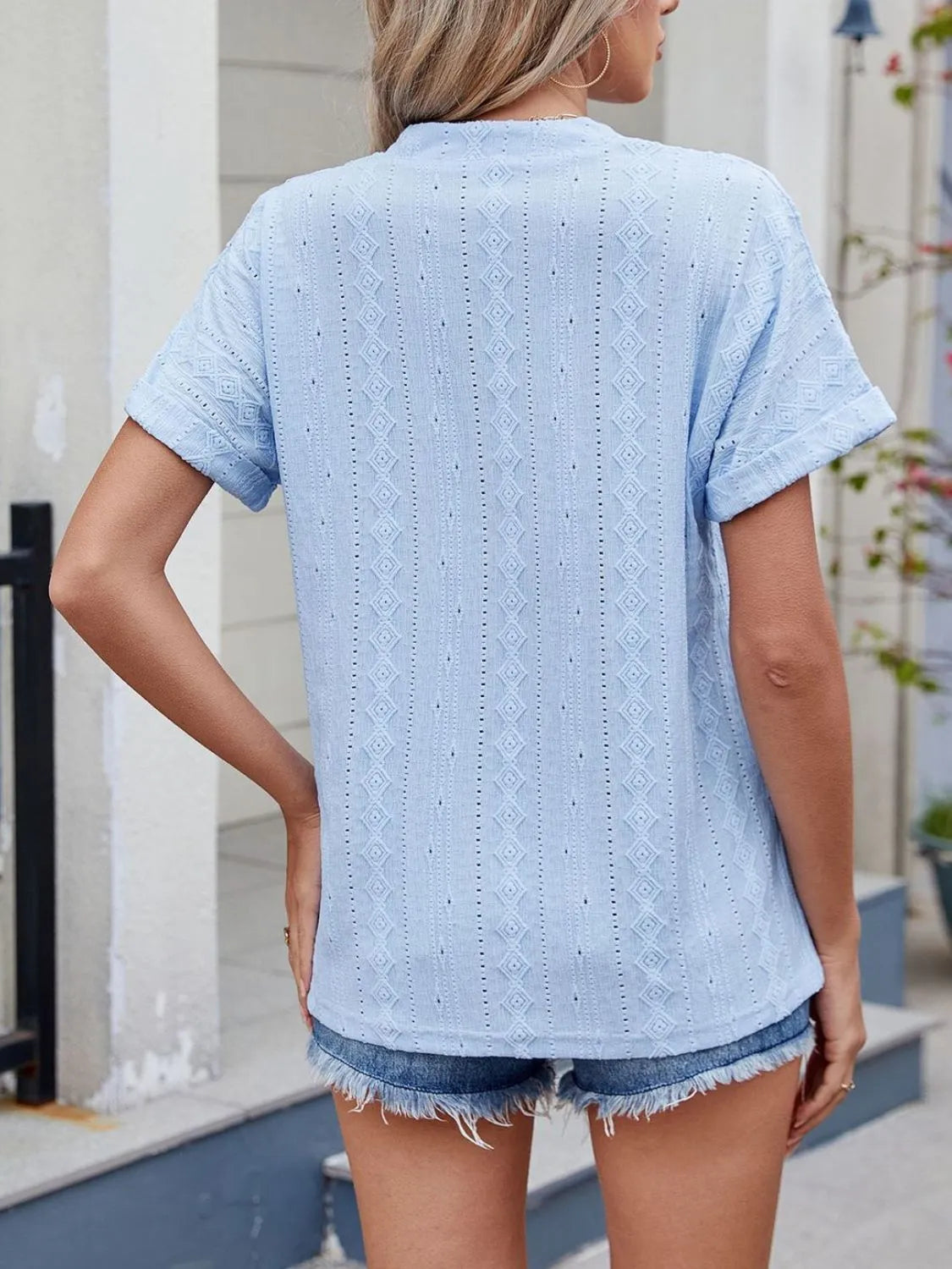 Eyelet notched short sleeve top.