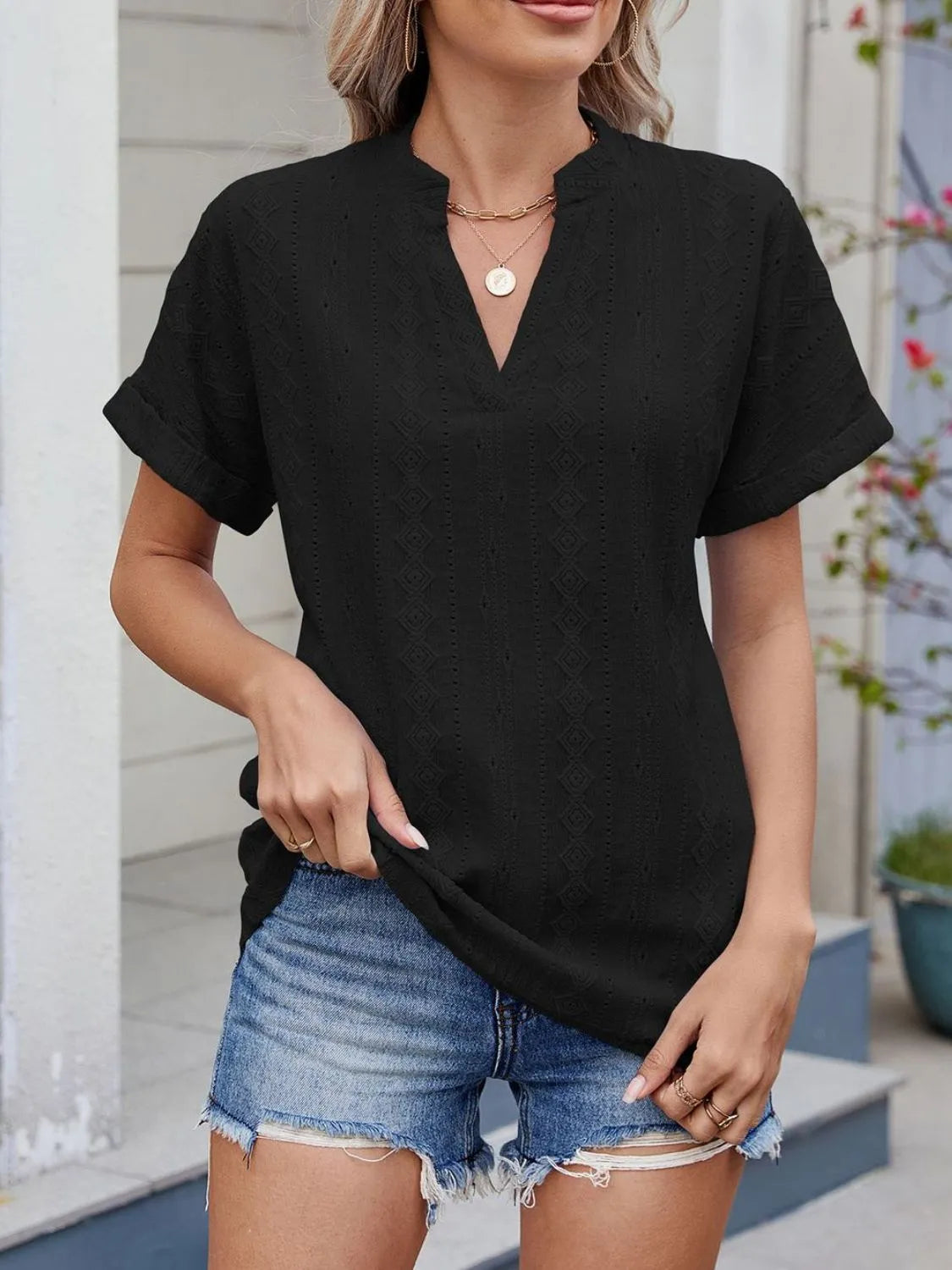 Eyelet notched short sleeve top.