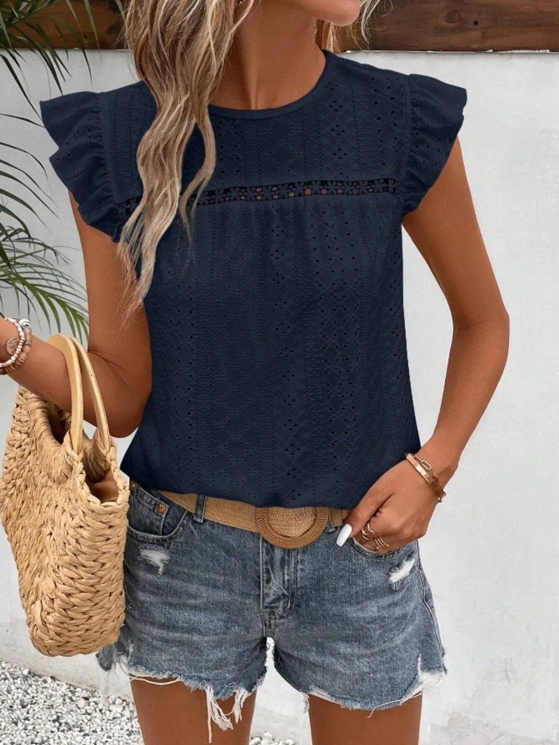 Eyelet round neck cap sleeve top with cutout.