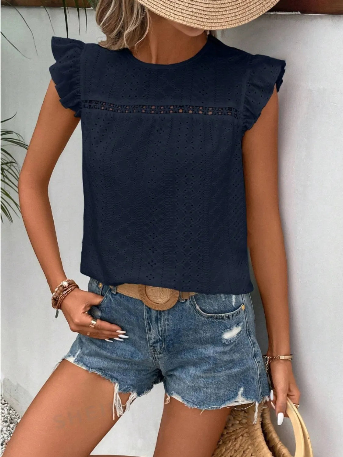 Eyelet round neck cap sleeve top with cutout.