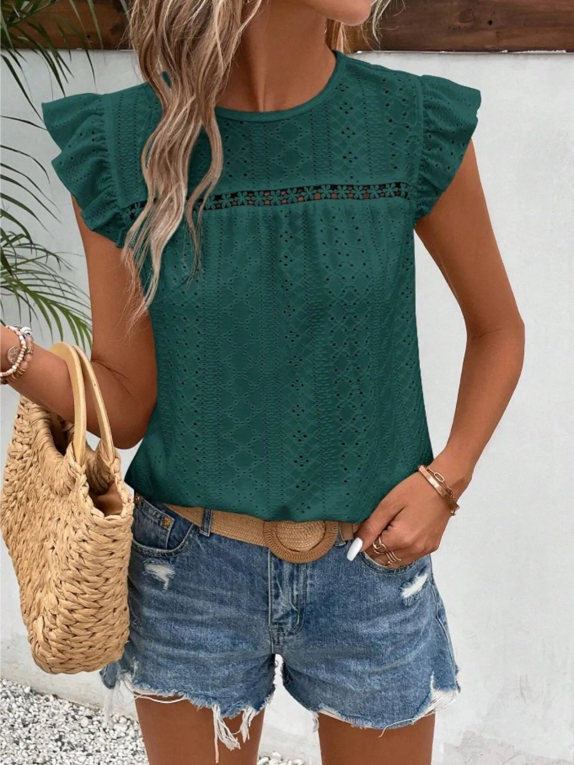 Eyelet round neck cap sleeve top with cutout.