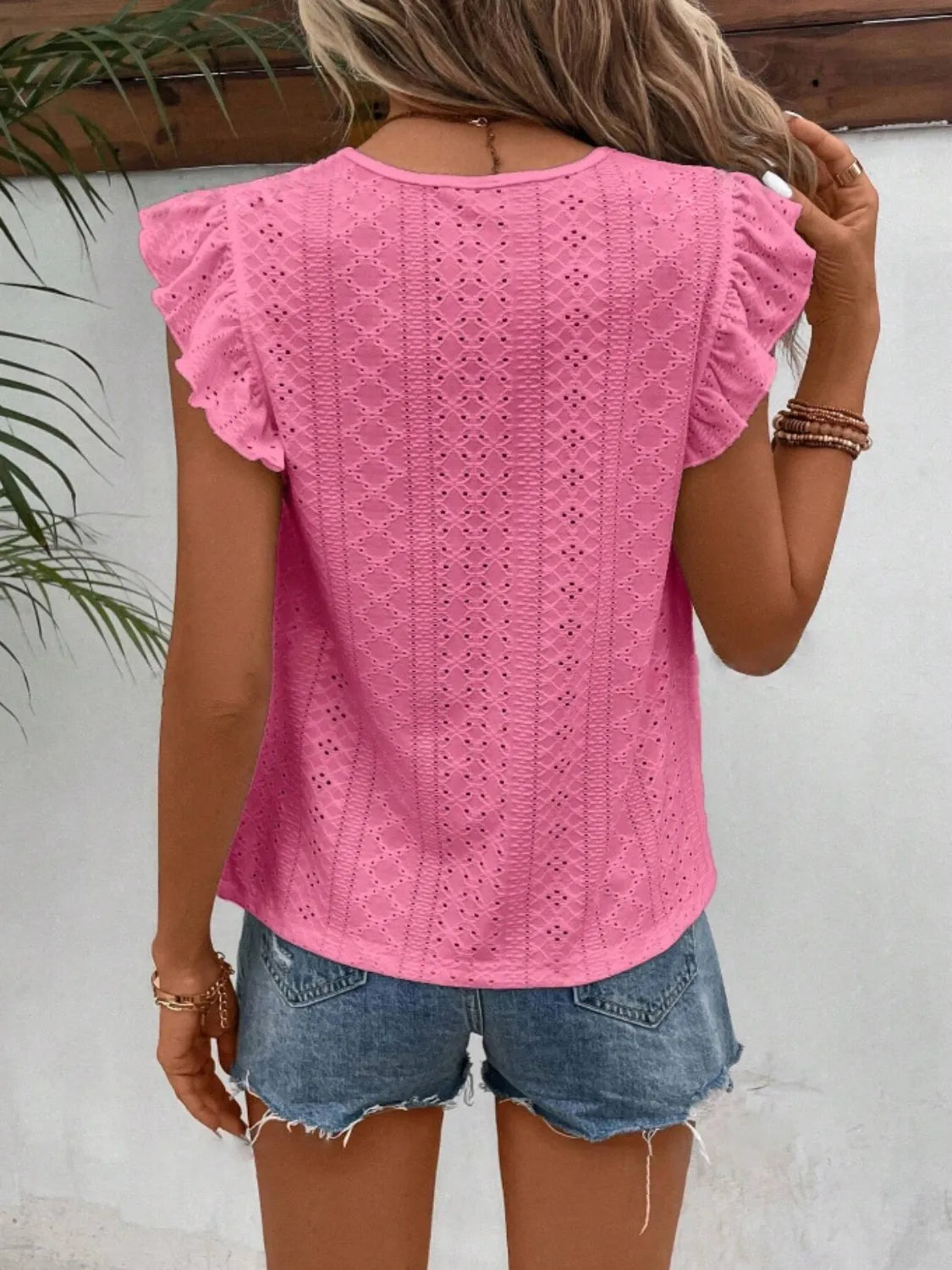 Eyelet round neck cap sleeve top with cutout.