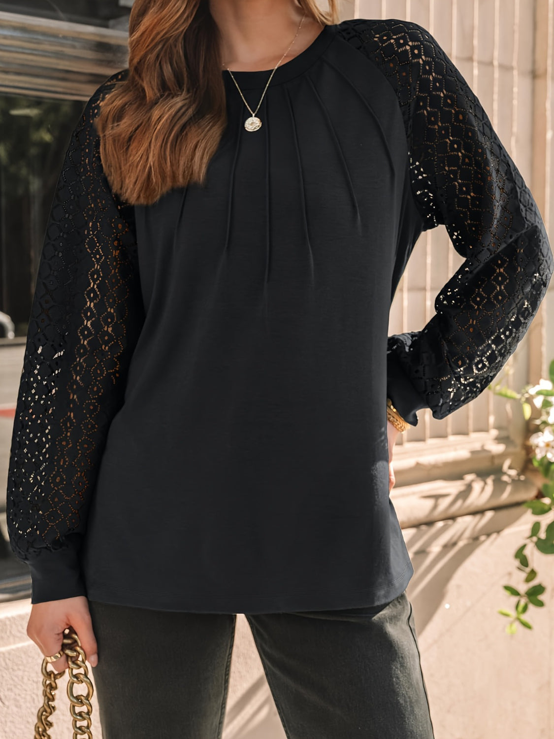 Eyelet round neck long sleeve blouse.
