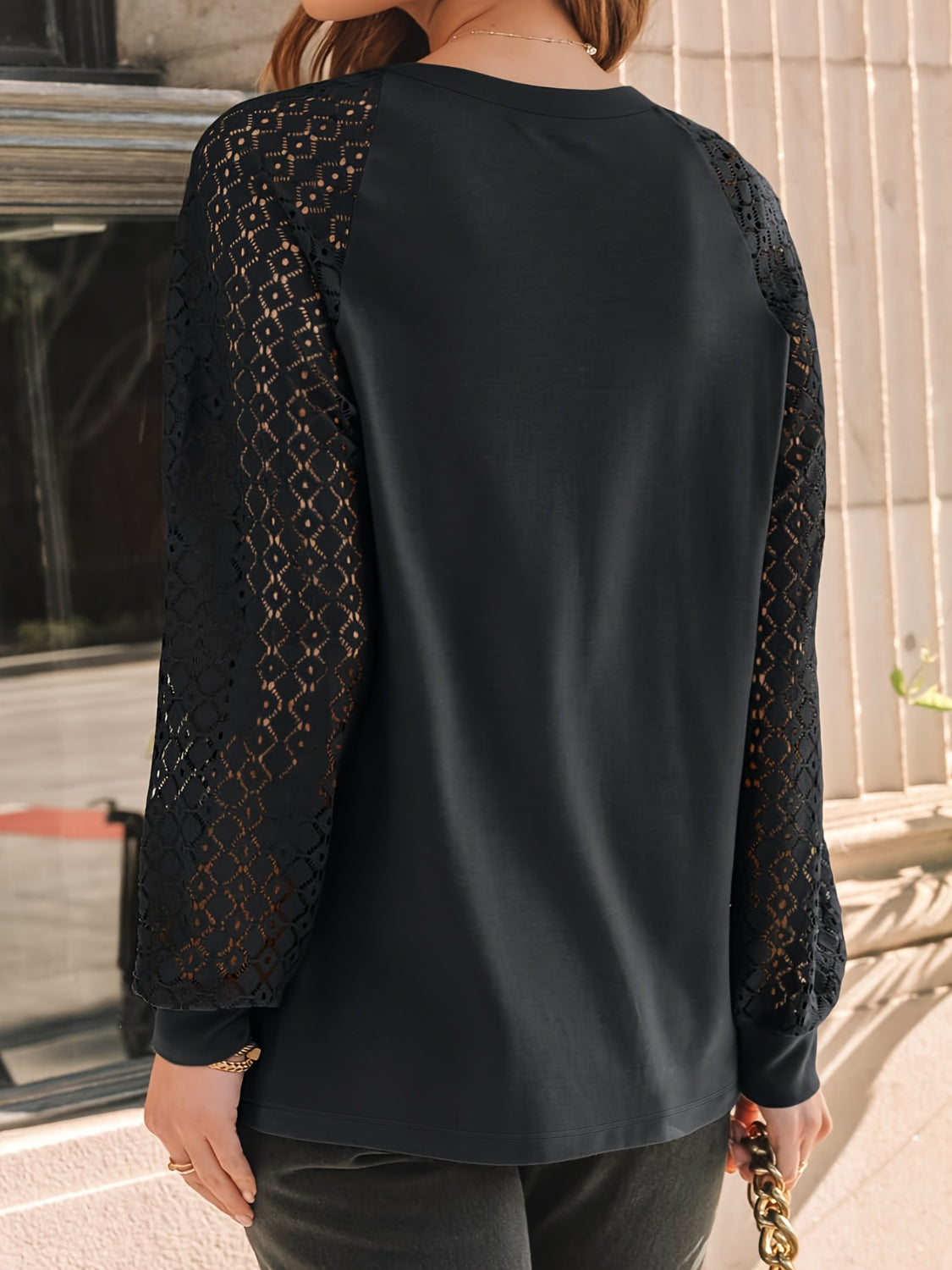 Eyelet round neck long sleeve blouse.