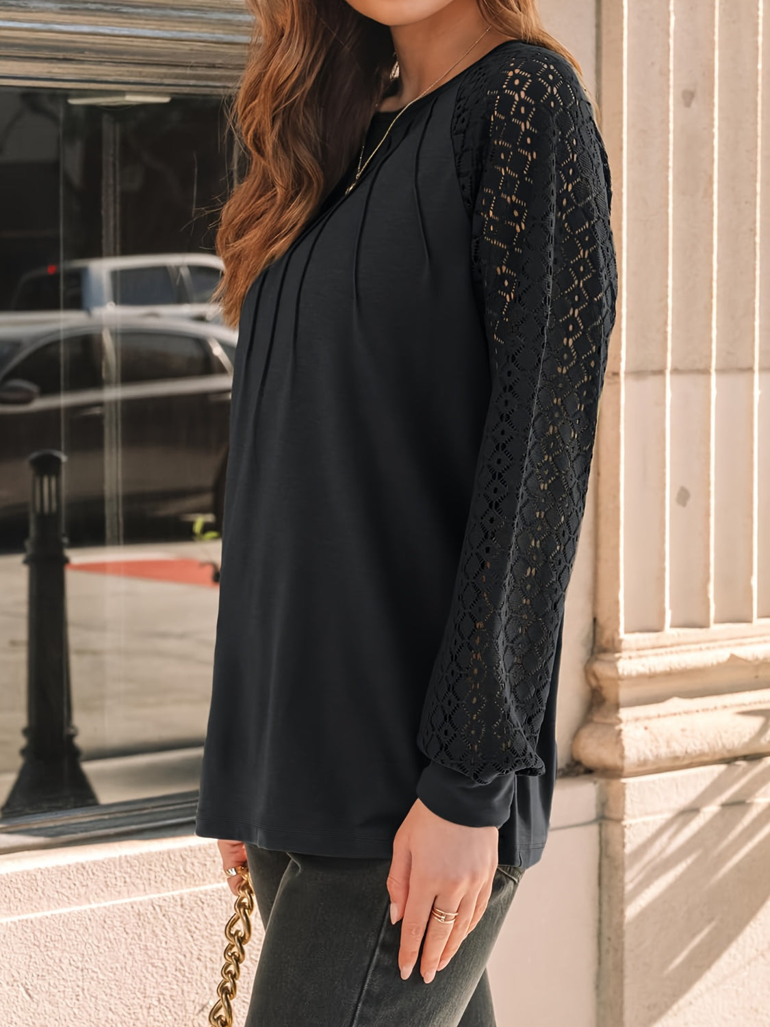 Eyelet round neck long sleeve blouse.