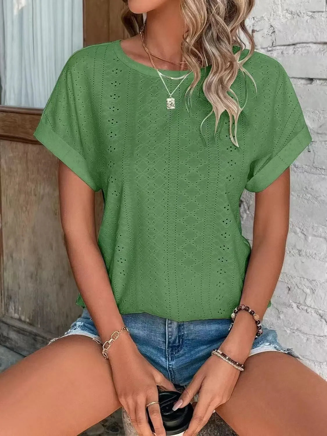 Eyelet round neck short sleeve top.