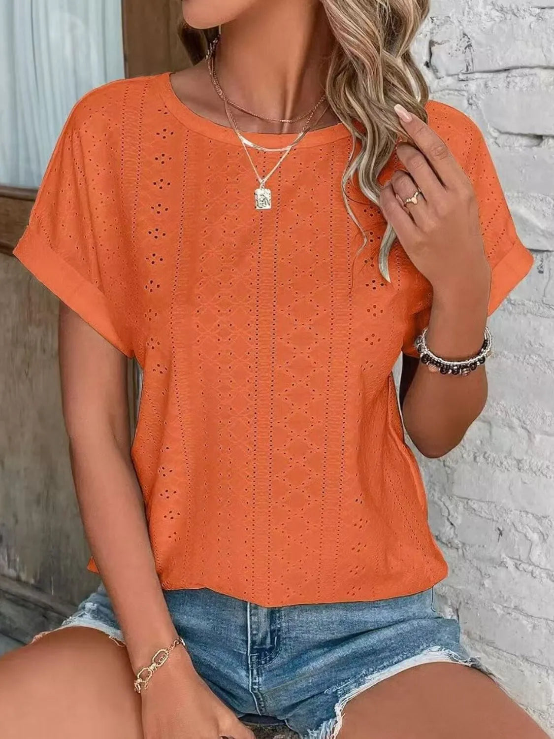 Eyelet round neck short sleeve top.
