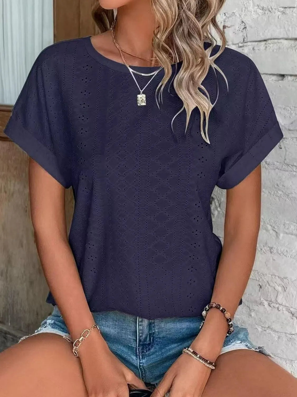 Eyelet round neck short sleeve top.