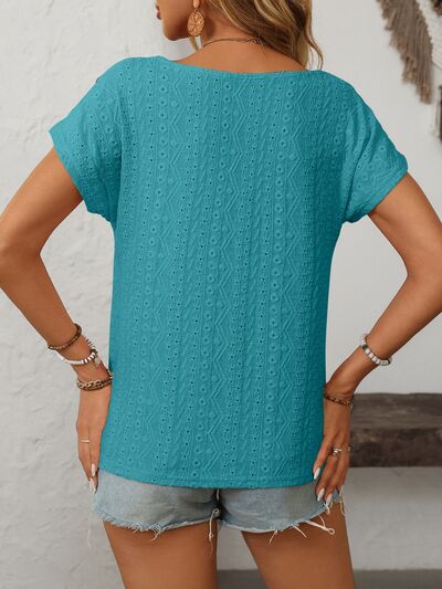 Mandy eyelet round neck short sleeve top with decorative buttons.