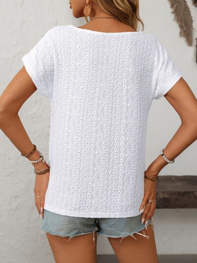 Mandy eyelet round neck short sleeve top with decorative buttons.