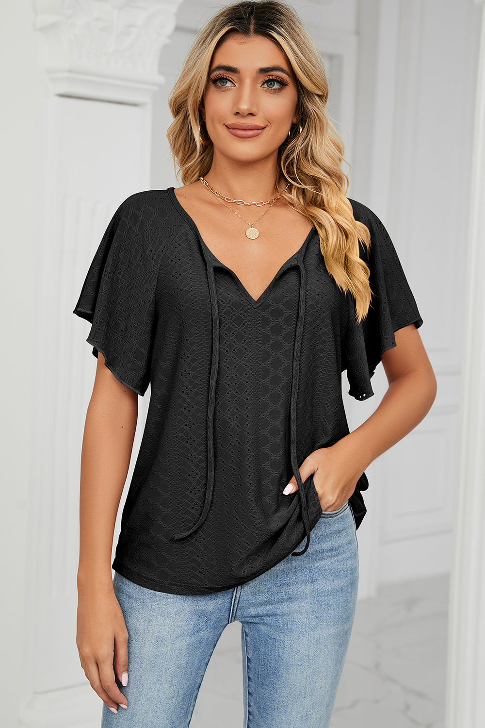 Eyelet tie neck flutter sleeve blouse.