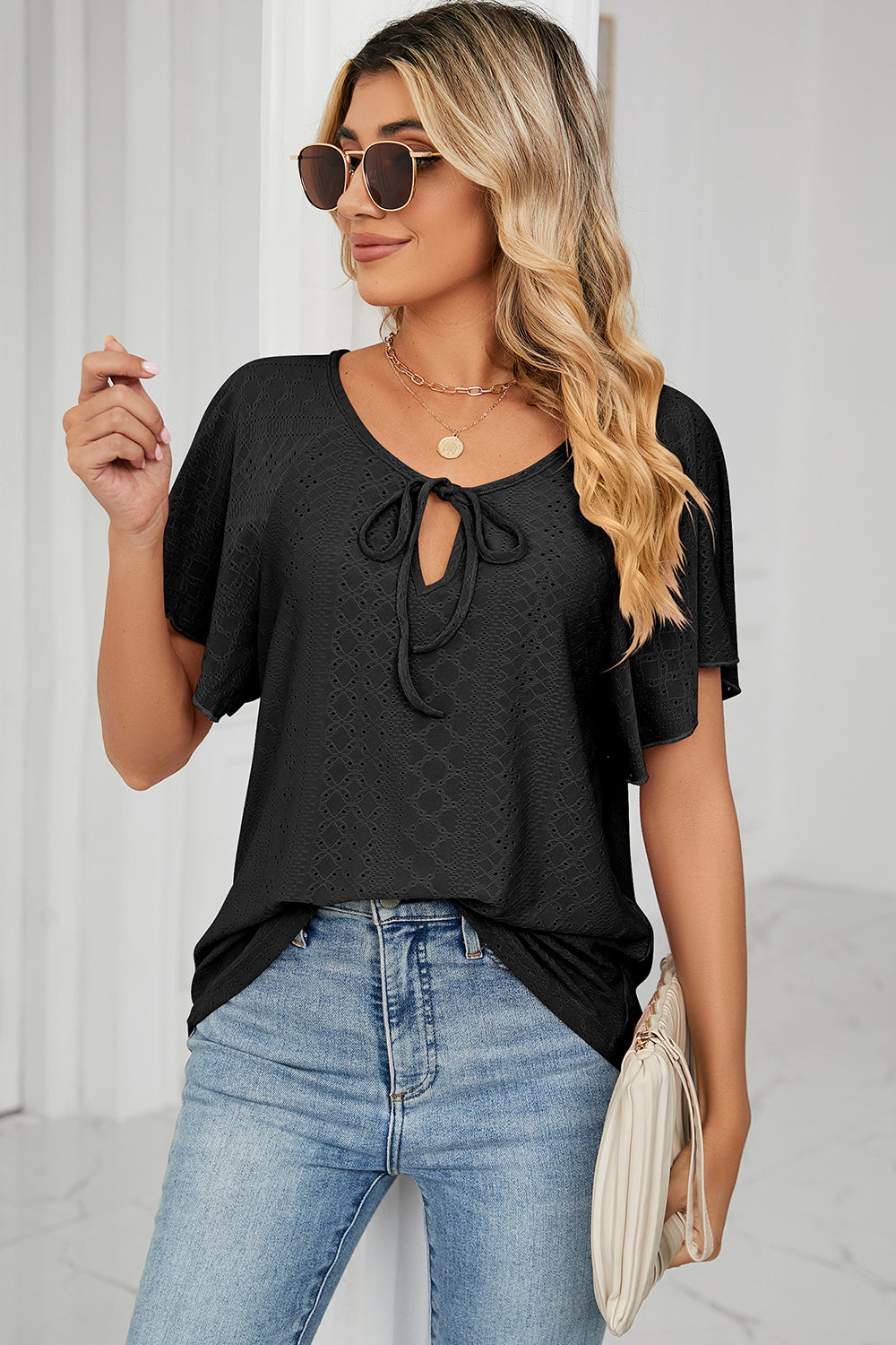 Eyelet tie neck flutter sleeve blouse.