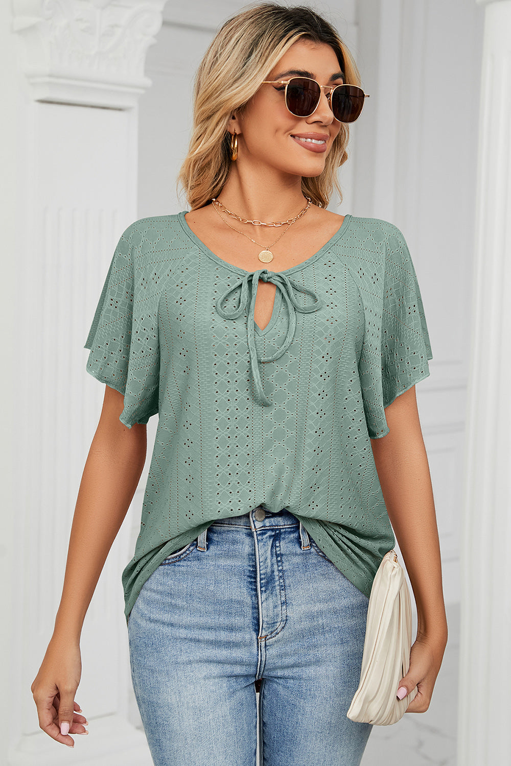Eyelet tie neck flutter sleeve blouse.