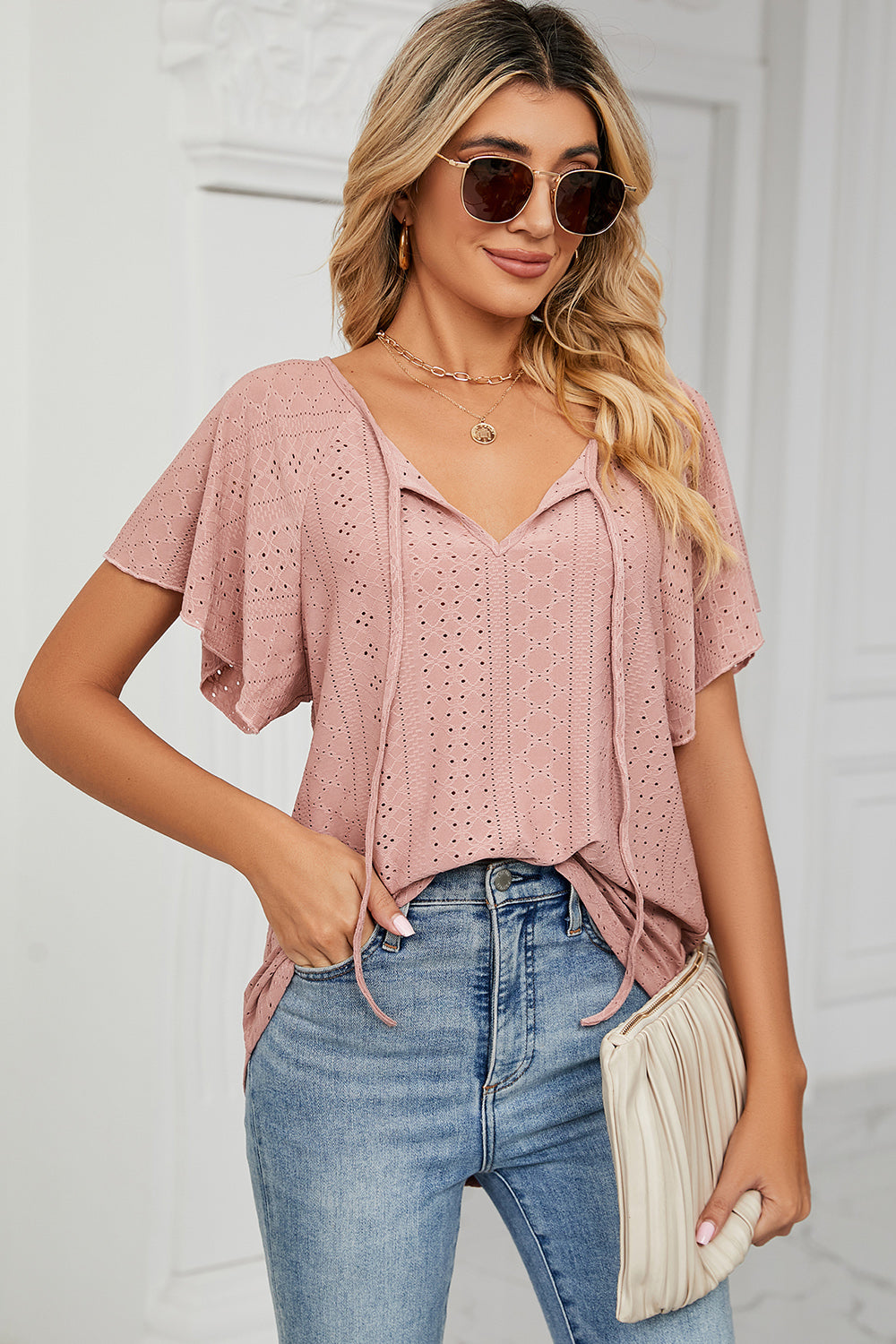 Eyelet tie neck flutter sleeve blouse.