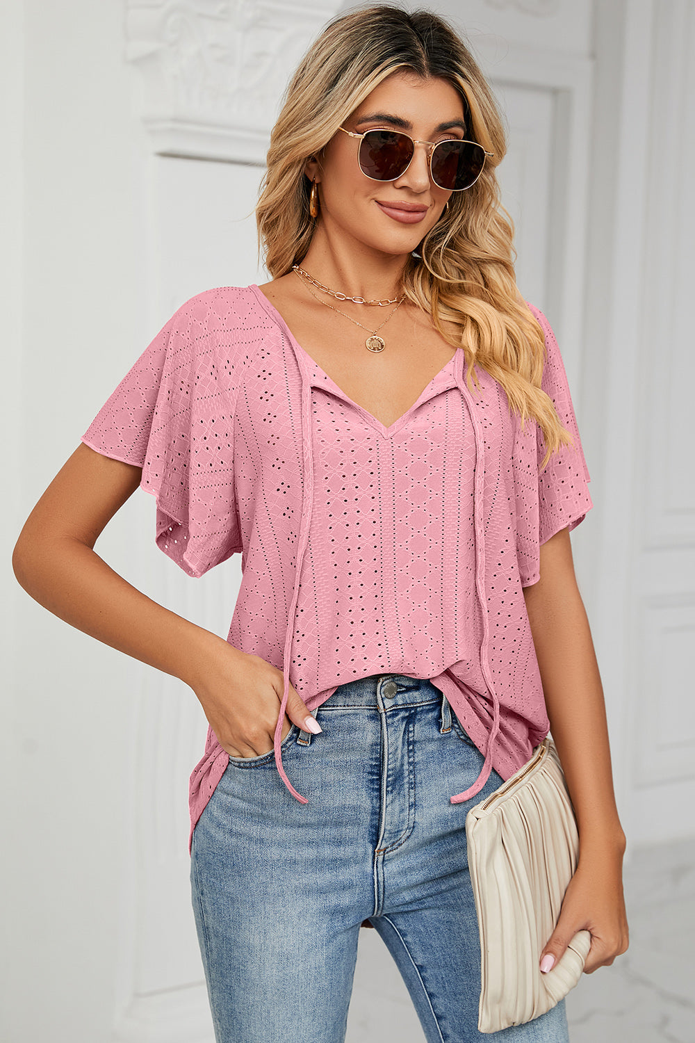 Eyelet tie neck flutter sleeve blouse.