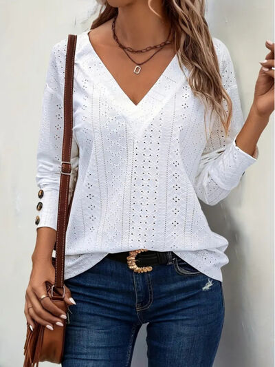Eyelet V-neck long sleeve blouse with cutout and decorative buttons.