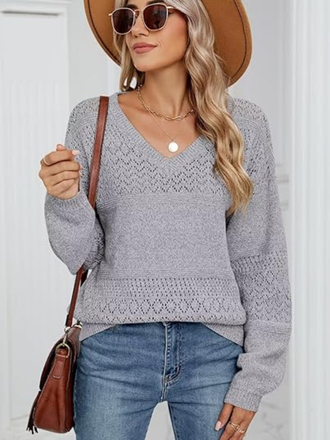 Eyelet V-neck long sleeve sweater.