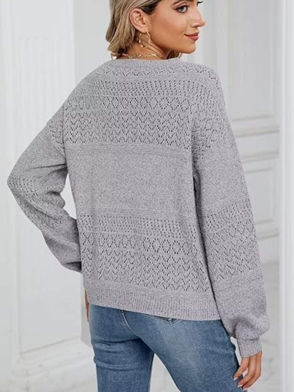 Eyelet V-neck long sleeve sweater.