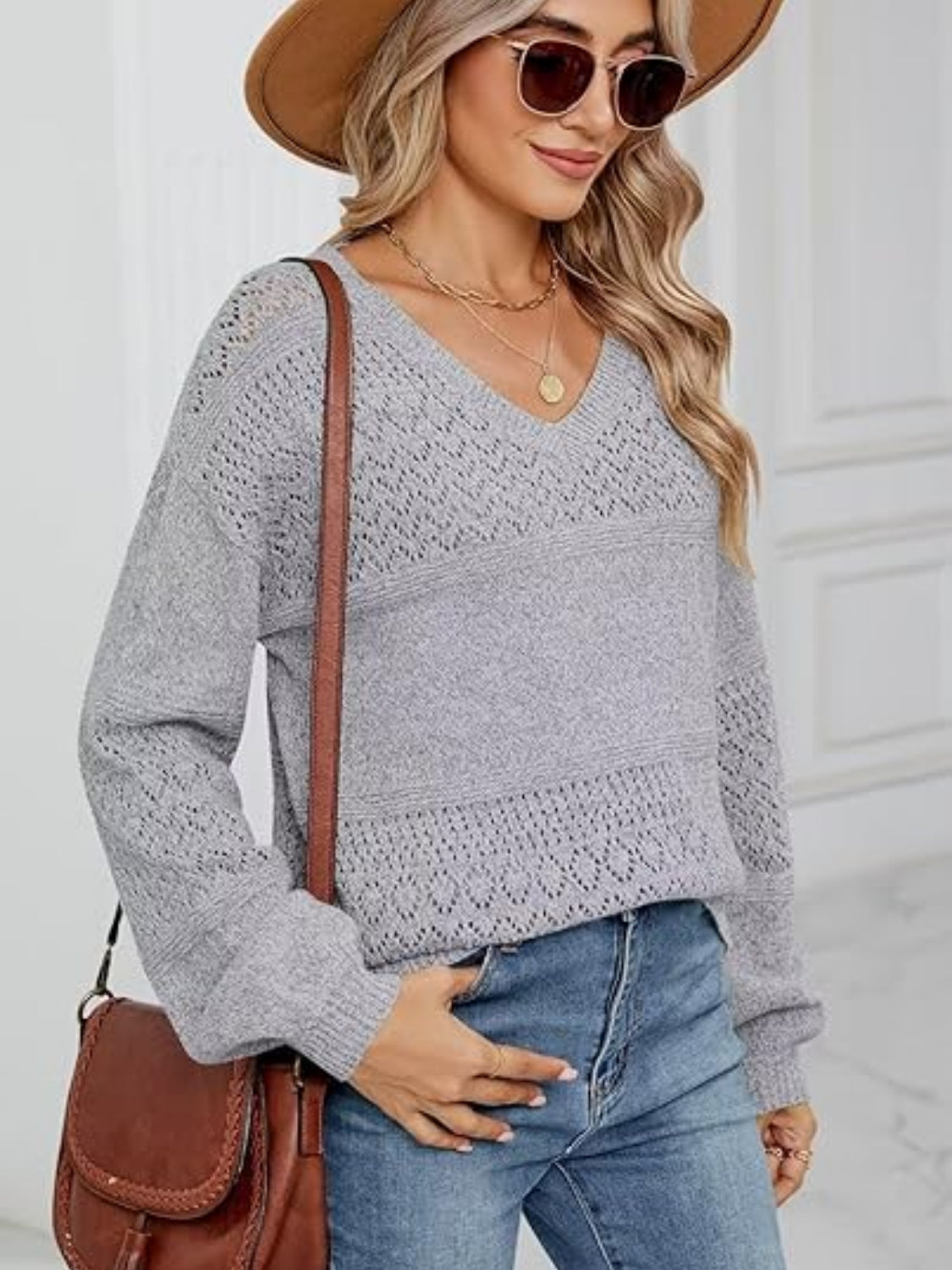 Eyelet V-neck long sleeve sweater.