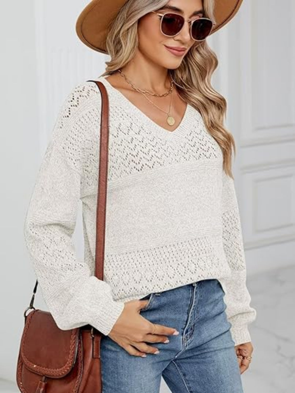 Eyelet V-neck long sleeve sweater.