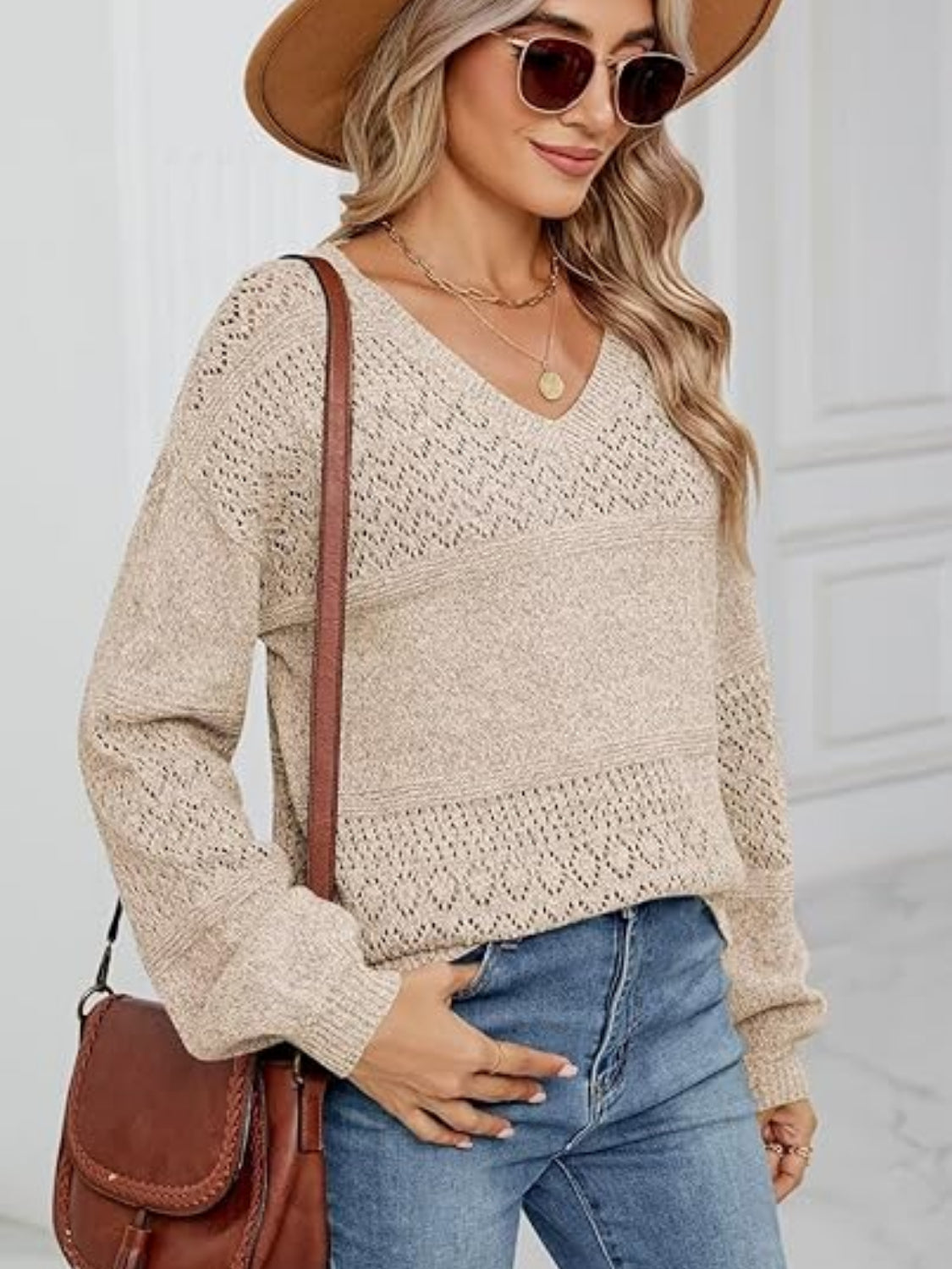 Eyelet V-neck long sleeve sweater.