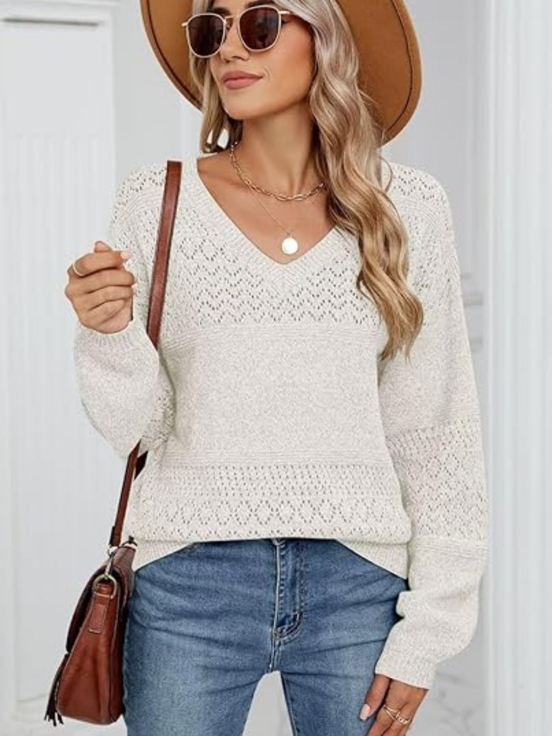 Eyelet V-neck long sleeve sweater.