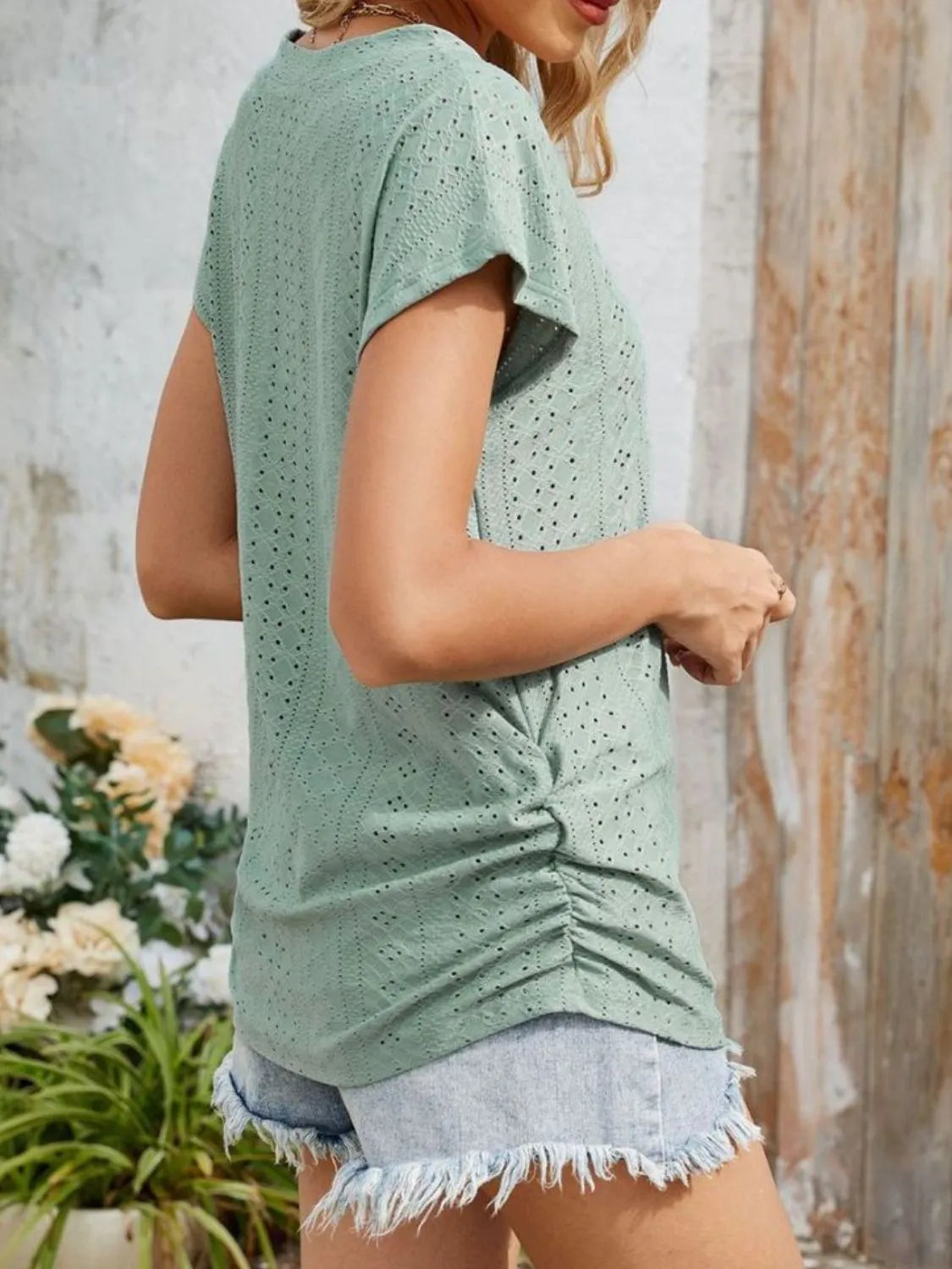 Eyelet V-neck short sleeve top with pockets.