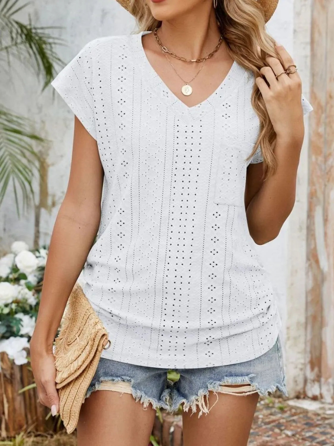 Eyelet V-neck short sleeve top with pockets.