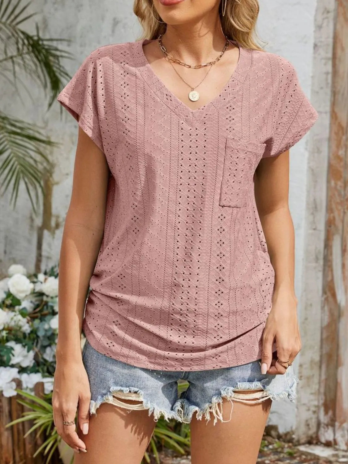 Eyelet V-neck short sleeve top with pockets.