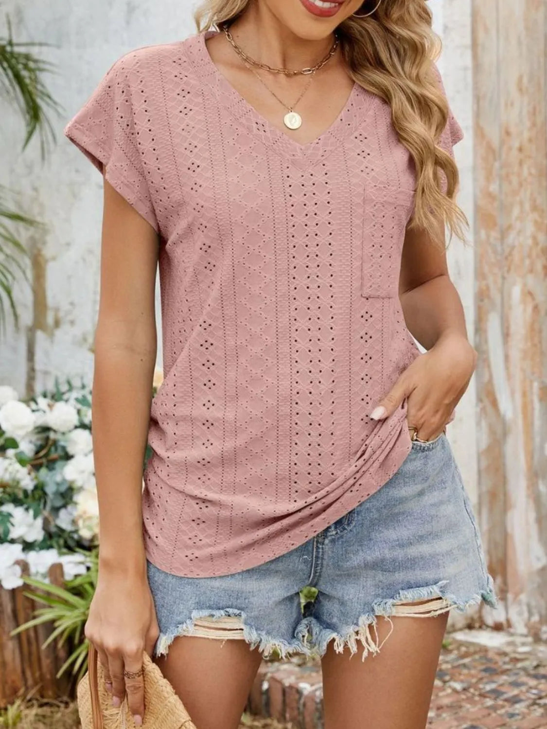 Eyelet V-neck short sleeve top with pockets.