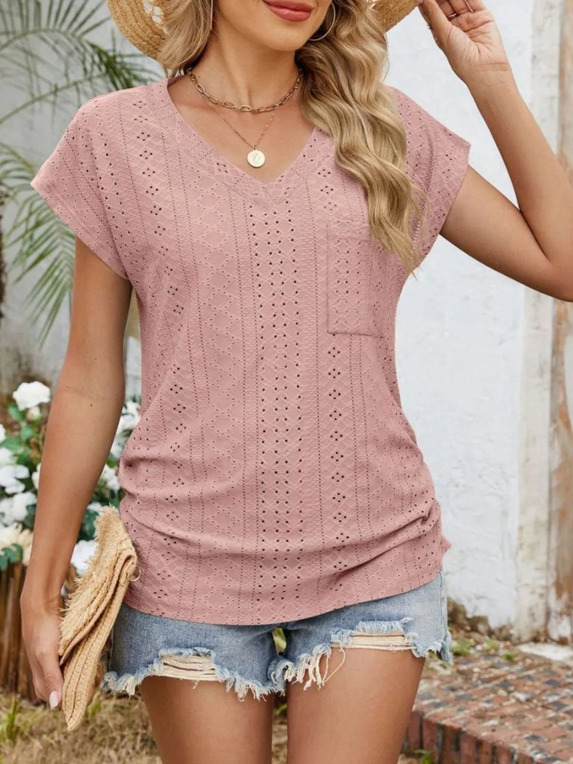 Eyelet V-neck short sleeve top with pockets.