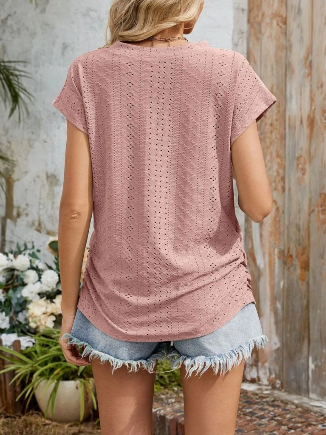 Eyelet V-neck short sleeve top with pockets.