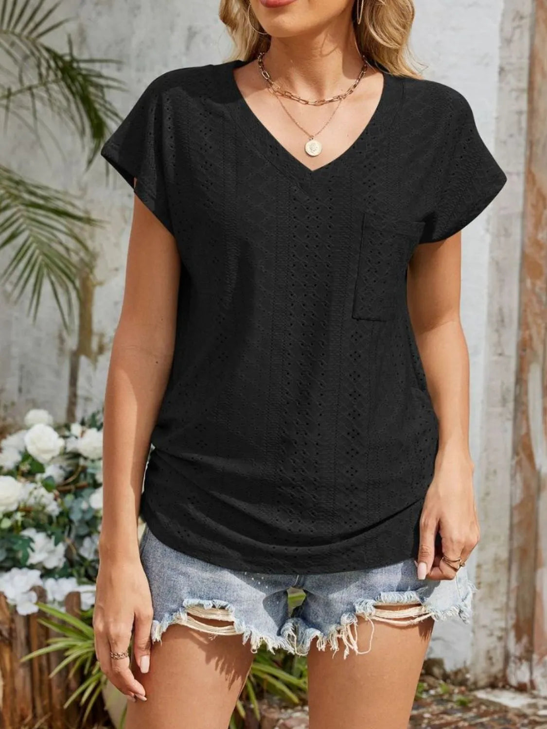 Eyelet V-neck short sleeve top with pockets.