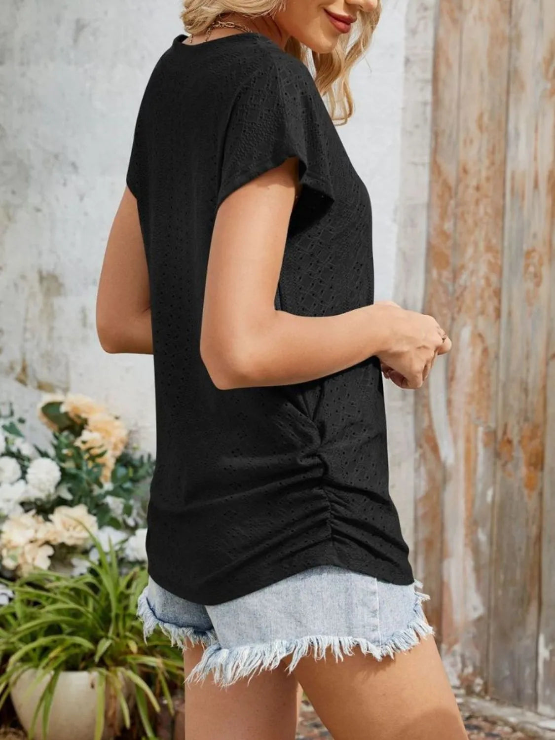 Eyelet V-neck short sleeve top with pockets.