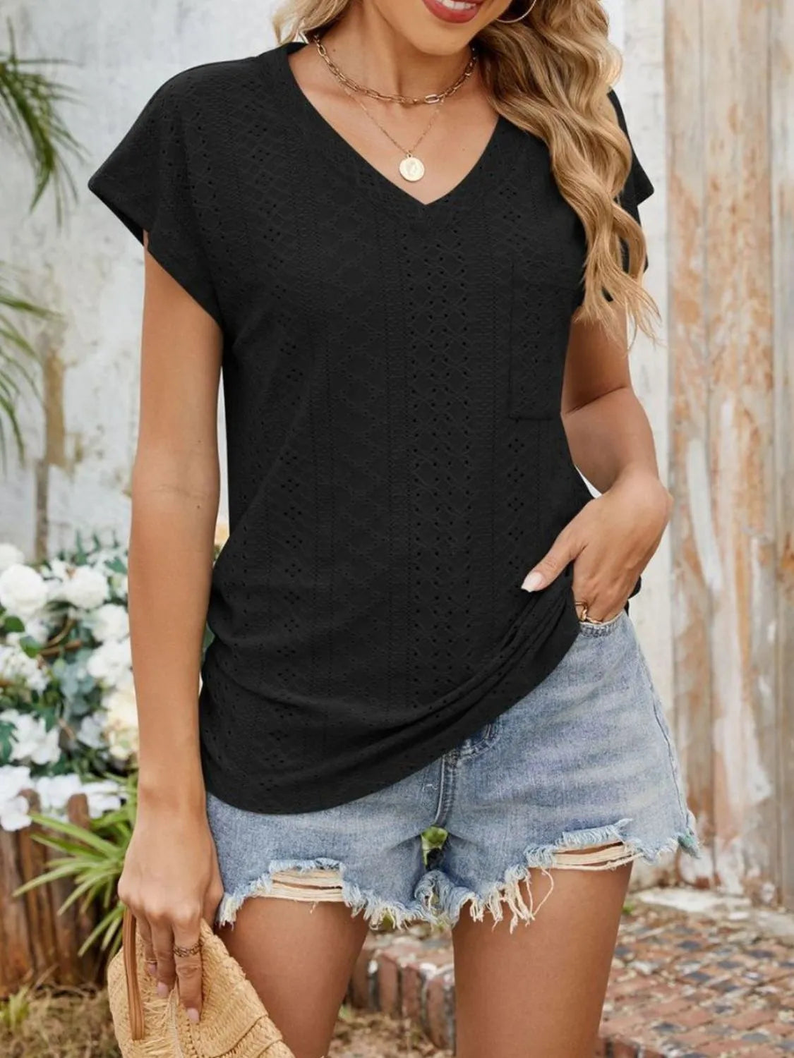 Eyelet V-neck short sleeve top with pockets.