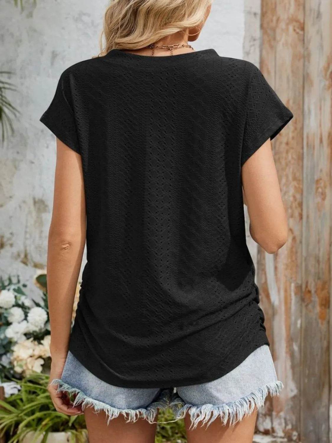 Eyelet V-neck short sleeve top with pockets.