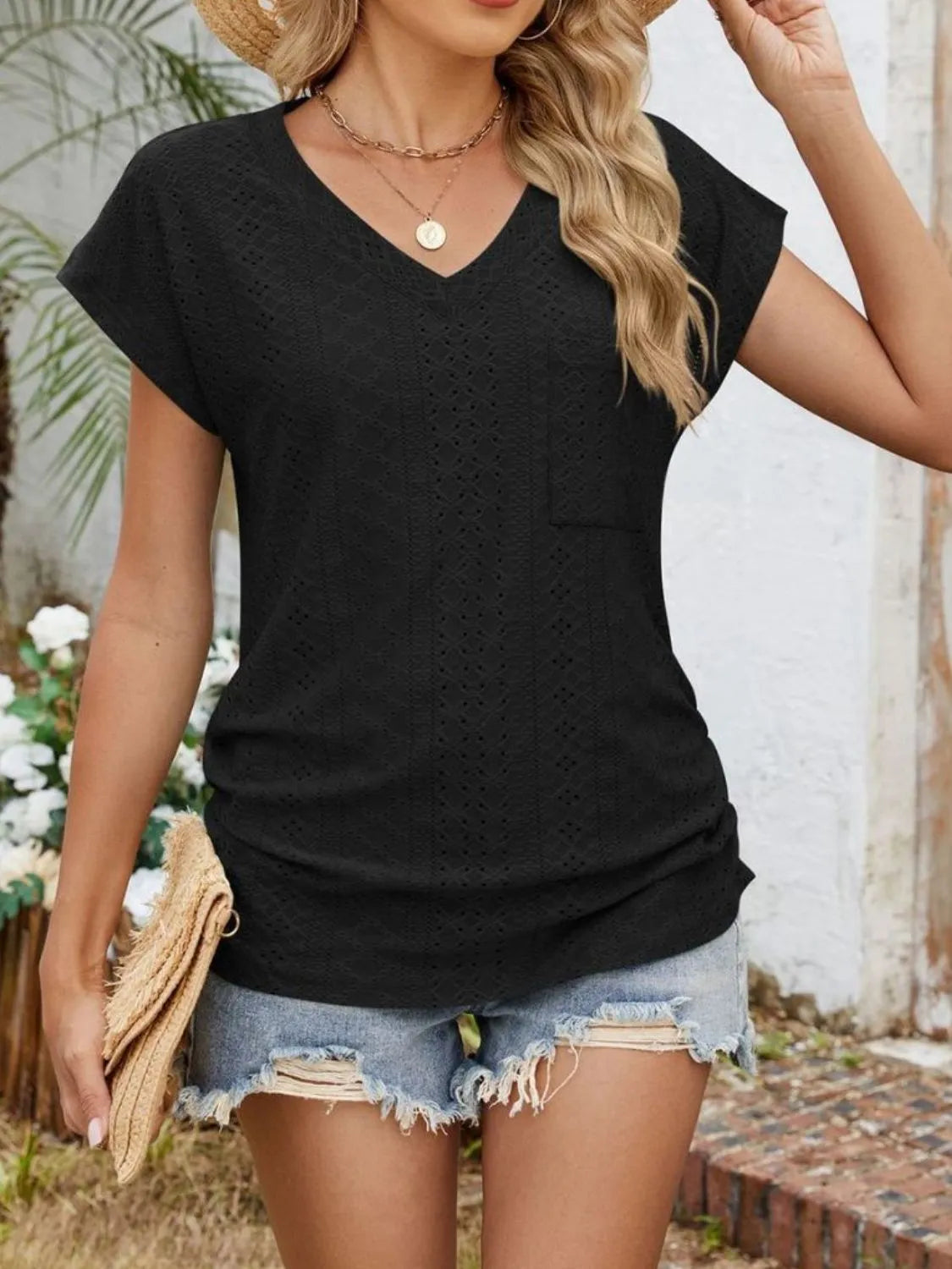 Eyelet V-neck short sleeve top with pockets.
