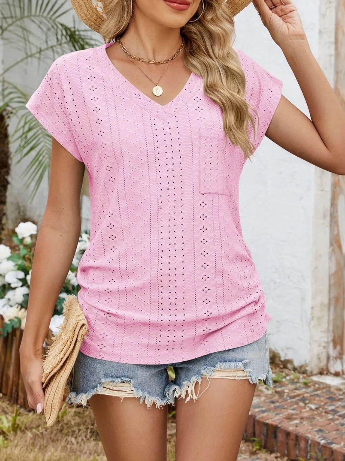 Eyelet V-neck short sleeve top with pockets.