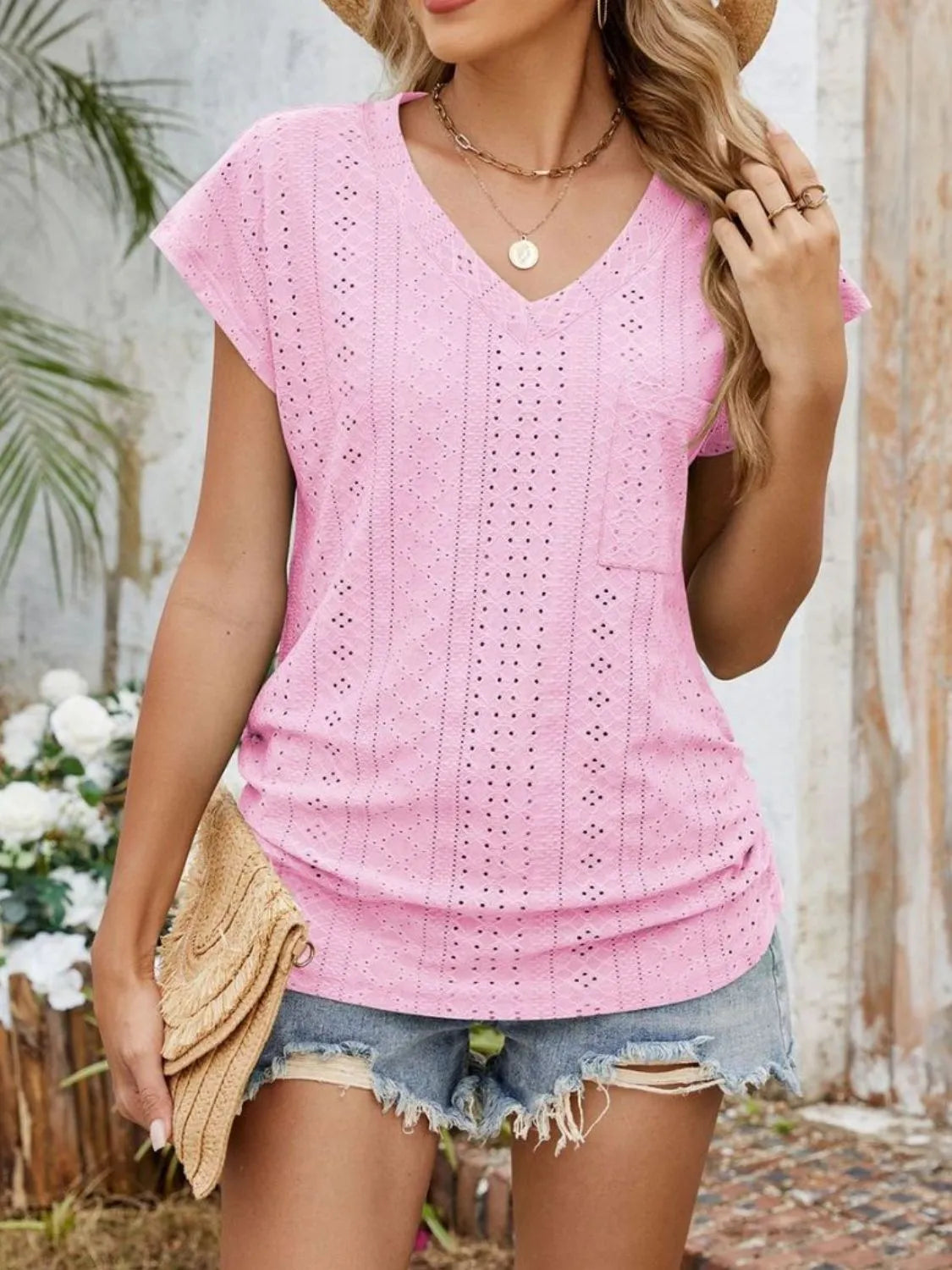 Eyelet V-neck short sleeve top with pockets.