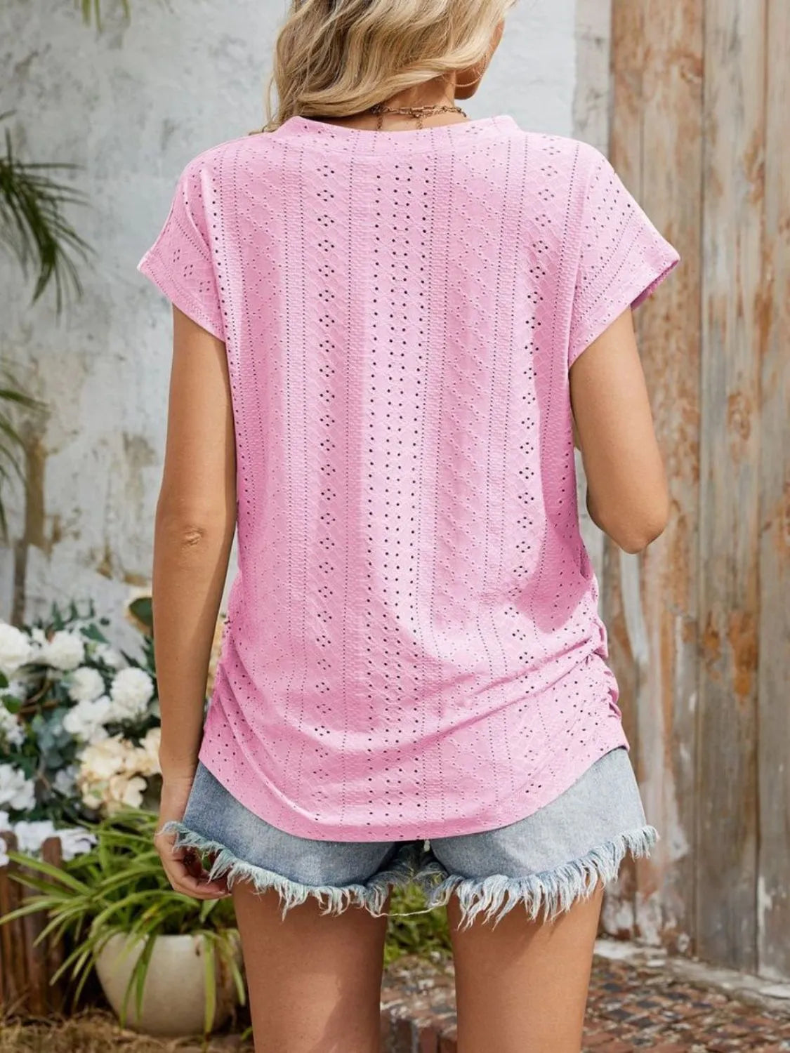 Eyelet V-neck short sleeve top with pockets.