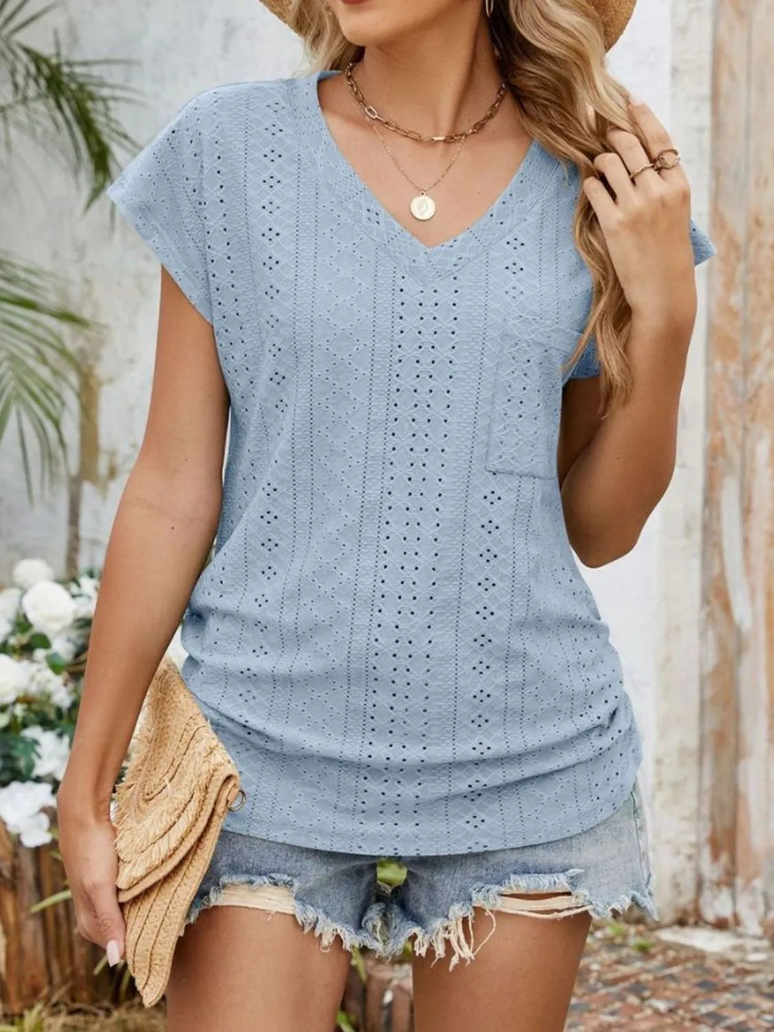 Eyelet V-neck short sleeve top with pockets.