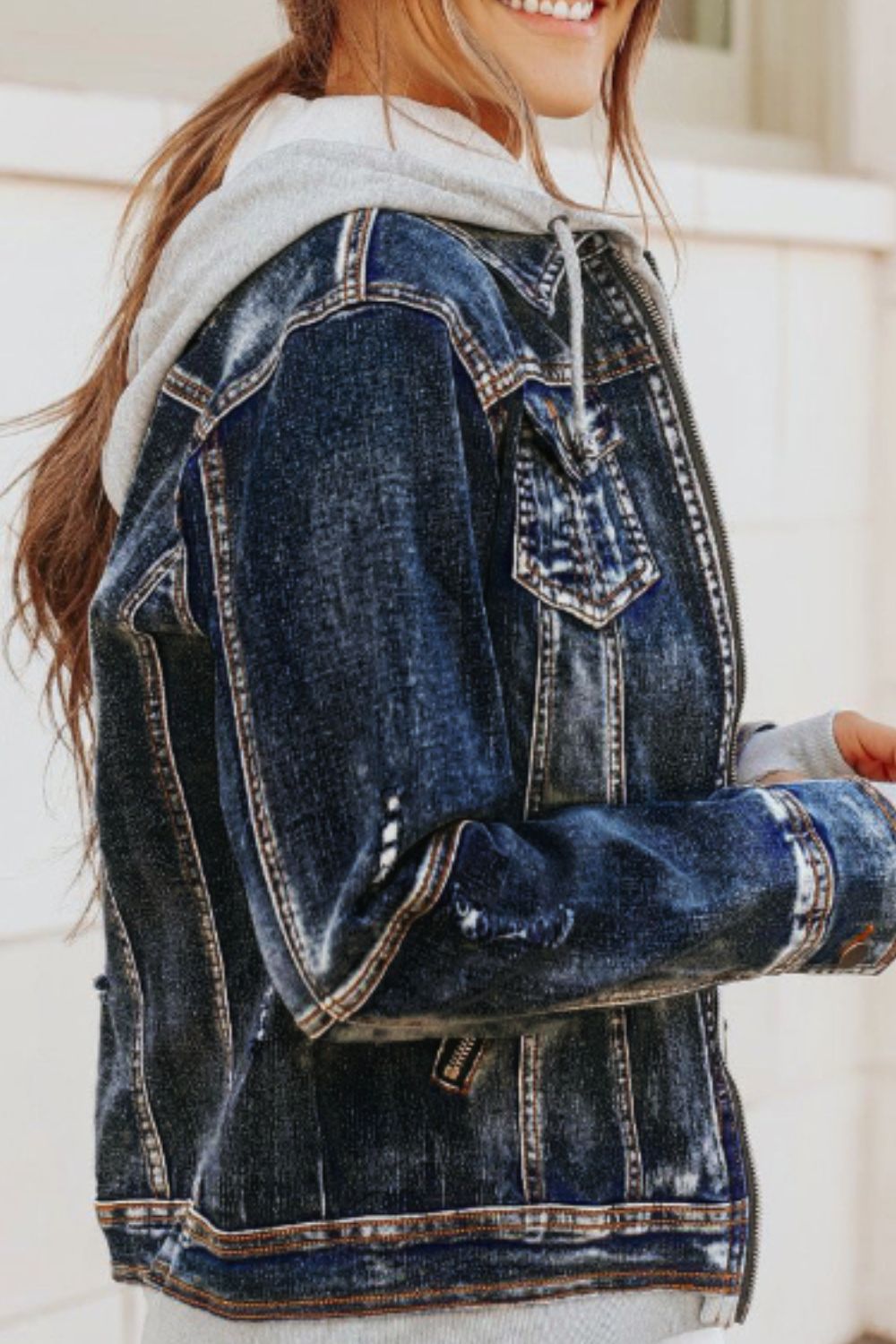 Distressed fake two-piece hooded zip-up denim jacket with buttoned pockets and drawstring.