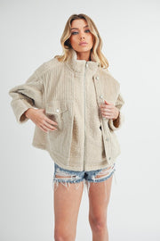 Fake two pieces turtleneck sherpa jacket with pockets and ribbed details.