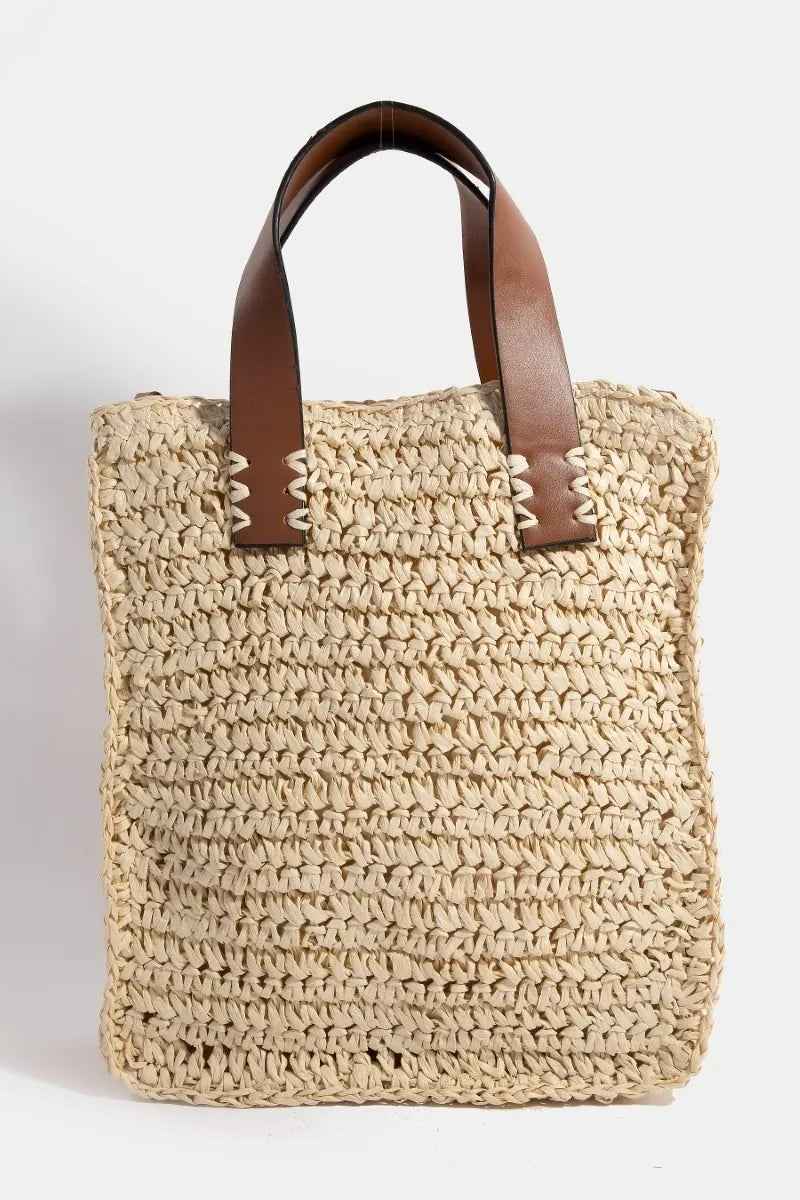 Medium faux leather handle straw braided handbag.
