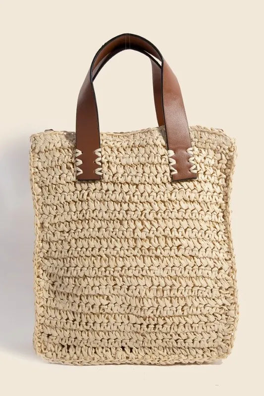 Medium faux leather handle straw braided handbag.