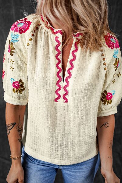 Floral embroidered notched puff sleeve blouse.